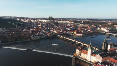 Flying-over-Prague-city-old-Town-rooftops,-Charles-bridge-over-river