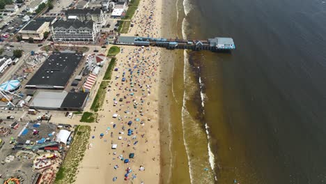 Drone-shot-of-Maine's-crowded-Old-Orchard-Beach-on-a-sunny-day