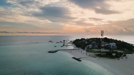 Establishing-aerial-view-of-Fulidhoo-local-island-in-Maldives-at-sunset