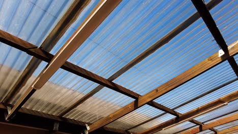 Wooden-Garage-With-Skyview-Roofing-On-Sunny-Day