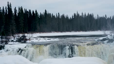 Static-time-lapse-4K-Panning-Shot-of-environment-nature-Tourism-Travel-Landmark-frozen-winter-Pisew-Kwasitchewan-Falls-Waterfall-Provincial-Park-near-Thompson-Manitoba-Northern-Arctic-Canada-Landscape