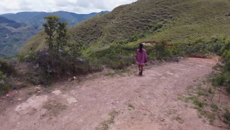 Female-tourist-enjoys-view-from-remote,-rugged-Bolivian-mountain-road