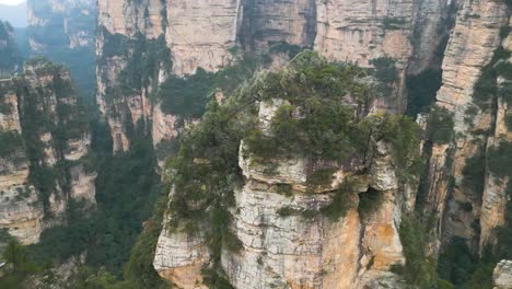 Aerial-orbiting-shot-of-the-columns-with-fog-in-Zhangjiajie-National-Park,-Avatar-Hallelujah-Mountains,-China