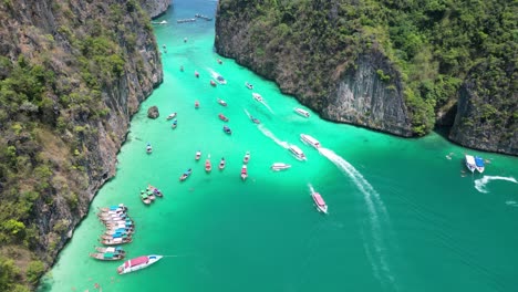 Tourism-and-tour-boats-at-crowded-Pileh-Lagoon-on-Phi-phi-island,-Aerial