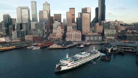 Seattle-Ferry-and-skyline-revealed-at-sunset-as-drone-retreats-up-to-reveal-panoramic-metropolis