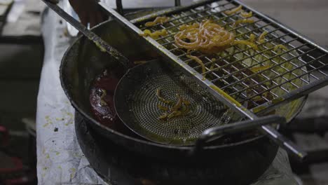 indian-traditional-sweet-jalebi-in-sugary-syrup-from-flat-angle