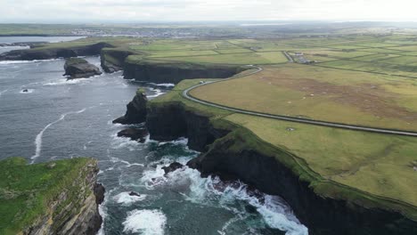 Kilkee-Cliffs-in-Ireland-with-lush-greenery-and-dramatic-coastline,-aerial-view