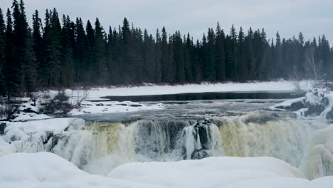 A-Slow-4K-Pan-up-Shot-of-environment-nature-Tourism-Travel-Landmark-frozen-winter-Pisew-Kwasitchewan-Falls-Waterfall-Provincial-Park-near-Thompson-Manitoba-Northern-Arctic-Canada-Landscape