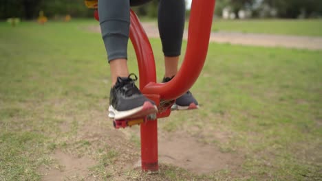 The-Lady's-Feet-While-Using-a-Pedal-Exercise-Device-in-the-Park---Close-Up