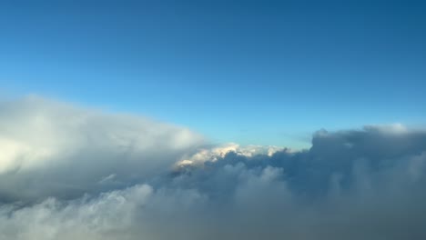 Flying-over-a-cold-and-clouded-winter-sky-shot-from-an-airplane-cockpit-as-seen-by-the-pilots-during-a-right-turn