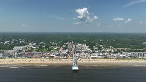 Wide-drone-shot-approaching-the-Old-Orchard-Beach-off-Maine's-coast