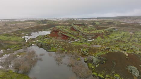 Aerial-landscapee-view-of-Raudholar-craters,-the-Red-Hills,-geological-formations-of-volcanic-terrain,-Iceland