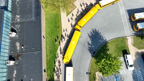 Aerial-view-of-students-walking-towards-buses-after-school-dismissal-in-USA