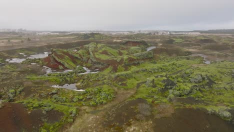 Aerial-panoramic-view-of-Raudholar-craters,-the-Red-Hills,-geological-formations-of-volcanic-rocks,-near-Reykjavik,-in-Iceland