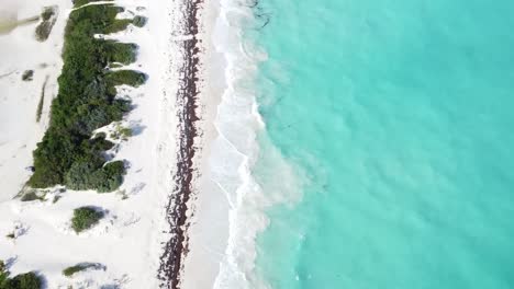 Isla-Blanca-with-clear-turquoise-waters-and-white-sandy-beach,-aerial-view