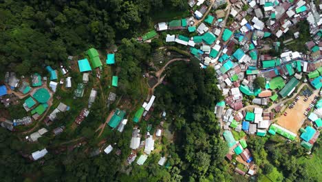 Mountainous-Village-with-Green-Rooftops,-Doi-Pui-Hilltribe-Hmong-Village,-Doi-Suthep-National-Park-in-Chiang-Mai-Thailand,-Birds-eye-View-Drone-Footage