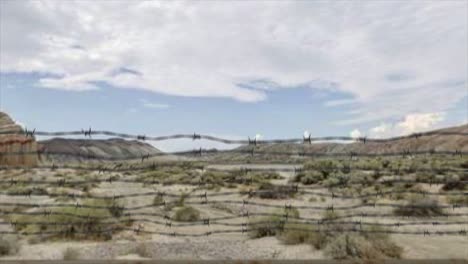 High-quality-3D-CGI-reveal-shot-rising-over-a-chainlink-fence-at-the-Area-51-military-installation-in-a-desert-scene,-with-a-UH60-Black-Hawk-helicopter-flying-overhead-and-into-the-distance