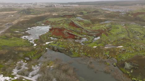 Aerial-landscape-view-of-Raudholar-craters,-the-Red-Hills,-geological-formations-of-volcanic-rocks,-near-Reykjavik,-in-Iceland