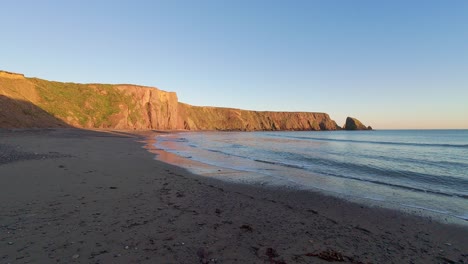 Golden-cliffs-and-sands-last-rays-at-Ballydwane-beach-Copper-Coast-Waterford-Ireland-on-a-bright-mid-winter-day