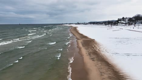 tracking-the-sandy-shore-as-winter-waves-crash-along-it