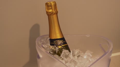 Orbit-shot-of-a-bottle-of-champagne-inside-a-bucket-of-ice