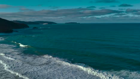Seascape-With-Foamy-Waves-Rolling-Onto-Shoreline---Aerial-Panoramic
