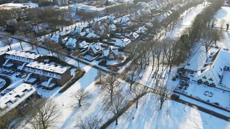 Cinematic-aerial-of-a-snow-covered-suburban-neighborhood