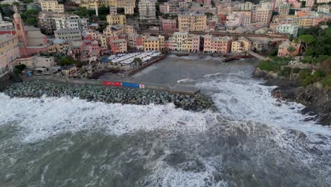 Big-foamy-sea-waves-crashing-on-pier-wave-braker-in-Genoa-city-harbor