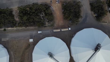 Silos-of-grain-and-truck-driving-by-site,-Industry-in-Western-Australia