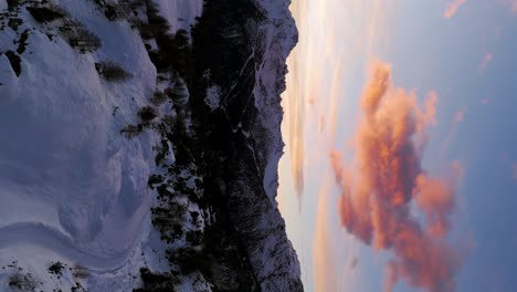 Flying-over-Valmalenco-Dolomites-Alpine-mountains-at-sunset-or-sunrise-in-Valtellina,-Italy