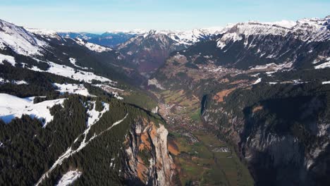 Scenic-aerial-view-of-Switzerland-mountain-valley-and-town-in-between