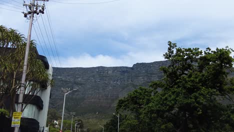 Driving-On-The-Road-Looking-At-Table-Mountain-Range-Through-Cape-Town,-South-Africa