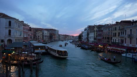 Grand-Canal-of-Venice-at-sunset-with-a-few-boats-and-only-one-gondola