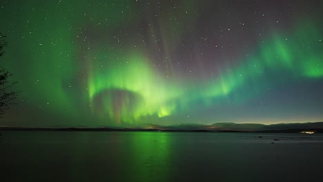 A-majestic-display-of-aurora-borealis-above-the-mirrorlike-surface-of-the-fjord