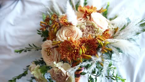 Pull-out-shot-of-wedding-bouquet-of-the-bride