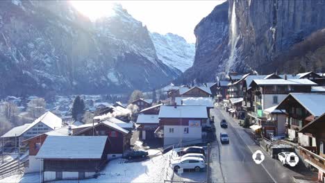 Lifting-Above-Snow-Covered-Homes-In-Village-|-Lauterbrunnen-Switzerland,-Swiss-Valley-in-Alps-Drone,-Europe,-4K