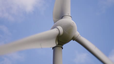 A-rotating-wind-turbine-in-the-close-up-shot-against-the-blue-sky