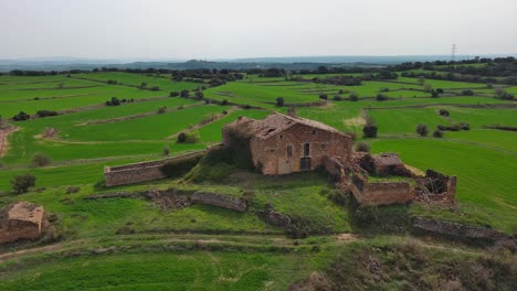Old-rustic-ruin-in-vibrant-green-fields,-capturing-a-sense-of-history-and-nature-near-Guissona-Spain