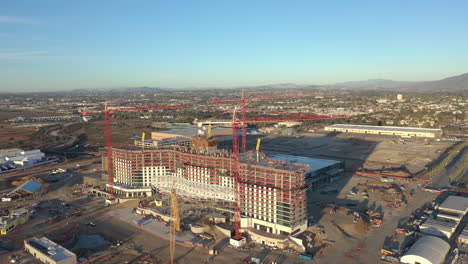Construction-of-the-new-convention-center-on-H-Street-in-Chula-Vista-California,-drone-orbit,-medium-wide-shot