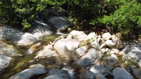 Closeup-Shot-of-ancestral-stones-under-the-sun,-clean-river-of-the-South-American-jungle-Minca,-Colombia