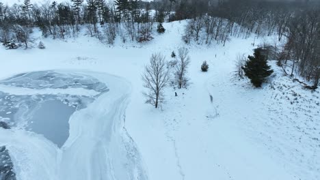 A-man-walking-a-dog-along-a-frozen-lake