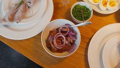 Pickled-herring-topped-with-red-onions-in-a-bowl