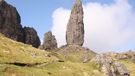 looking-up-at-the-giant-rock-pillars-of-old-man-of-storr-on-a-hike-on-Isle-of-Skye,-hIghlands-of-Scotland