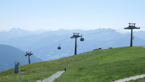 Tracking-shot,-cable-lifts-transporting-passengers-above-Austrian-resort