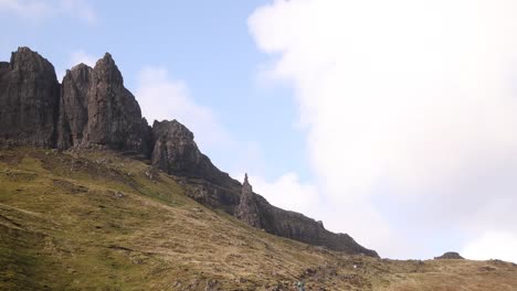 looking-up-at-the-black-cliff-face-of-Old-Man-of-Storr-on-Isle-of-Skye,-hIghlands-of-Scotland