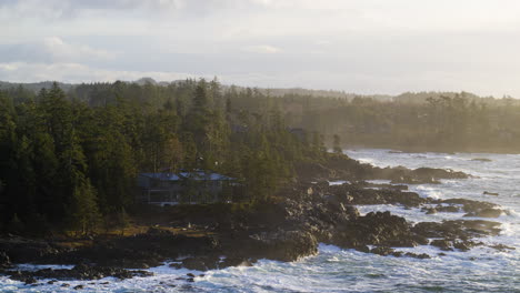 Drone-video-at-sunset-in-Ucluelet-British-Columbia,-Canada-over-the-ocean-and-forest