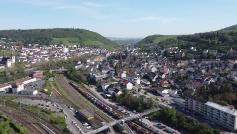 German-medieval-town-of-Bingen-amid-green-hills,-Aerial-dolly-in
