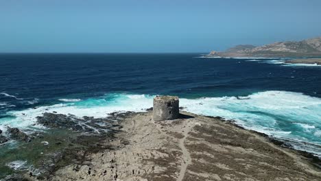 Sea-current-and-Waves-crashing-at-La-Pelosa-Tower-Sardinia,-Aerial