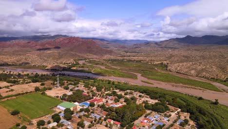 Drone-shot-flying-over-the-town-of-Molinos-in-Salta,-Argentina-towards-the-mountains