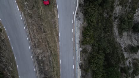 Red-car-parked-at-closed-curve-side-on-BV4608-road,-near-Vinyoles-and-Sobremunt